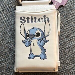 Stitch cross bag. Holds phone has Zipper on side. And Card holder on back. NWOT